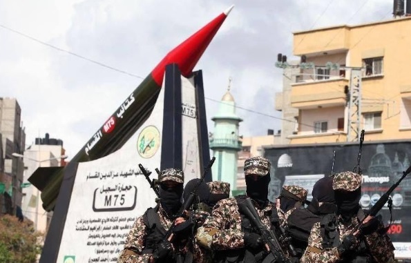 Hamas terrorists displaying a rocket.